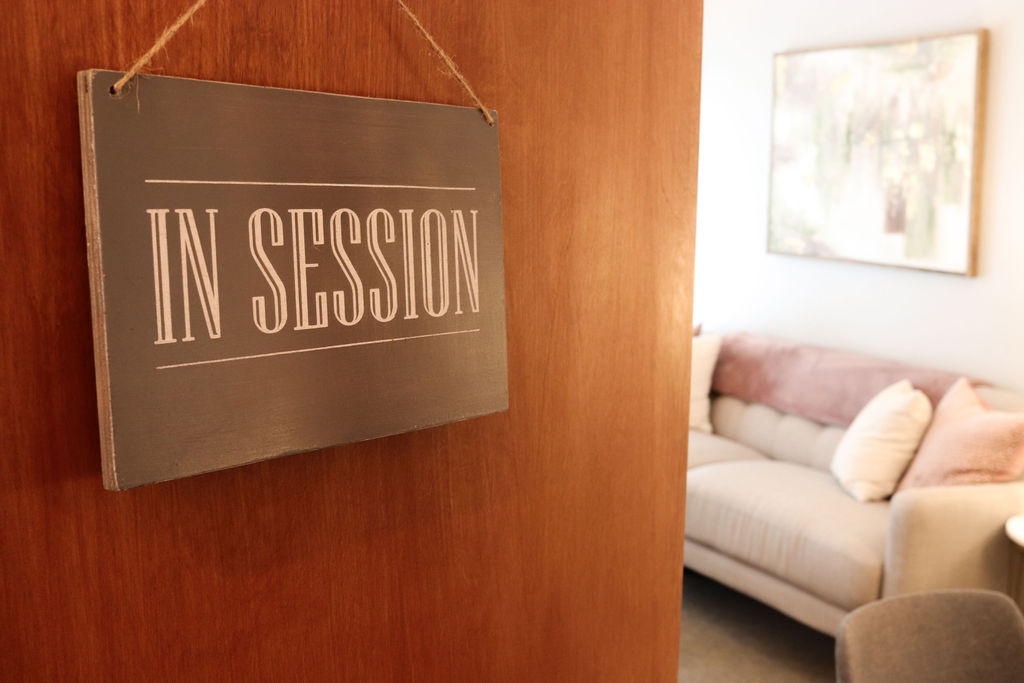 "In Session" sign on door entering therapist office.